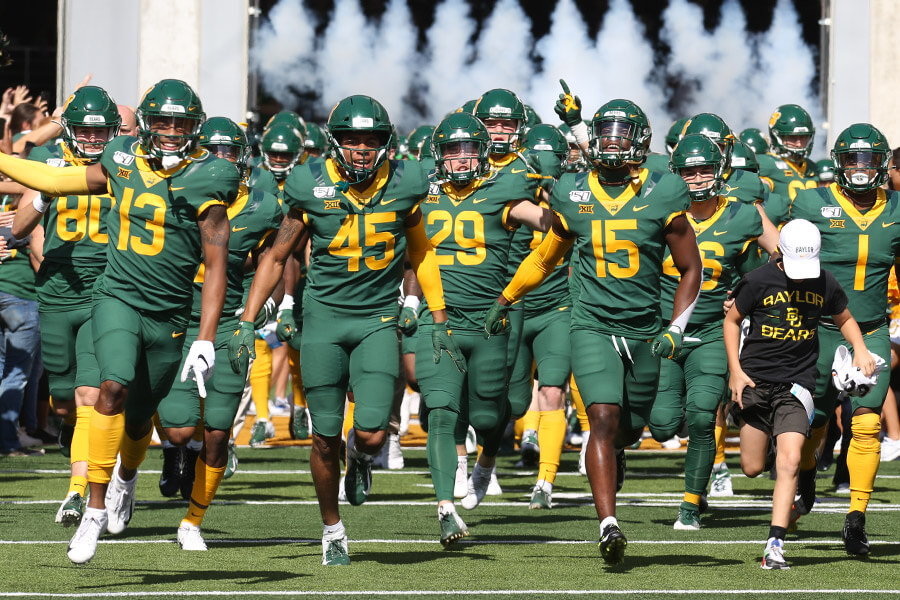 The Baylor football team running onto the field.