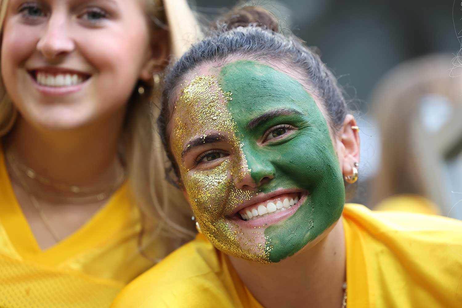 A Baylor Student with Green and Gold face paint